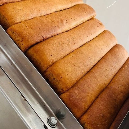 Whole wheat and millet loaves fresh out of the oven at Early Foods, before they are sliced and baked again into rusks
