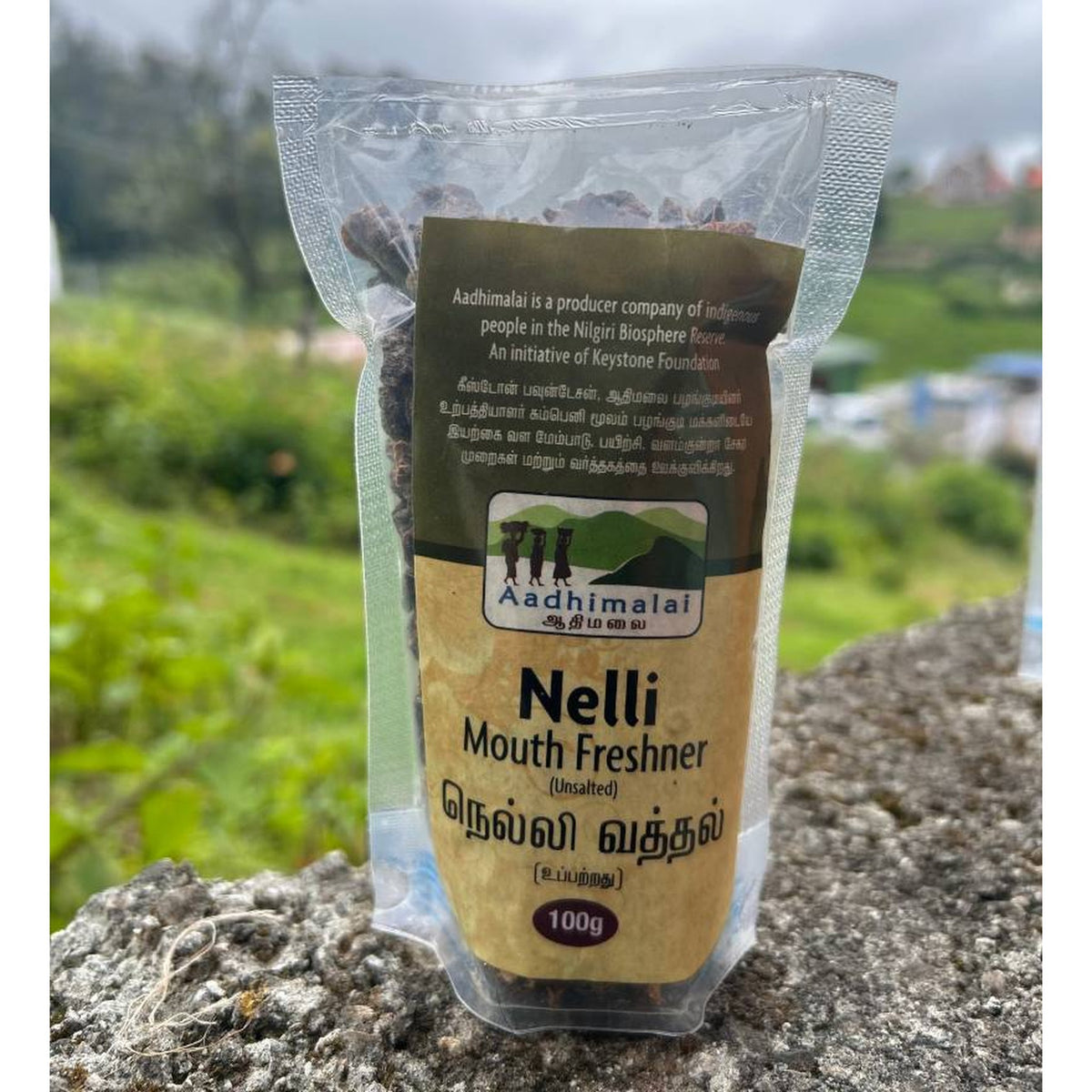 Unsalted Nelli Mouth Freshener 100g pouch photographed outdoors in the Nilgiris