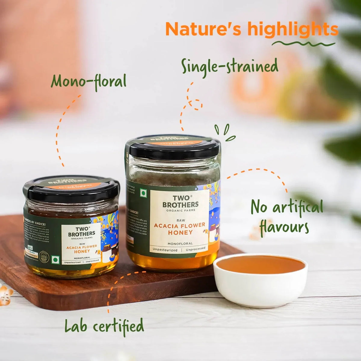 Two Brothers Acacia Flower Honey graphic showing two jar sizes on a wooden board beside a bowl of honey