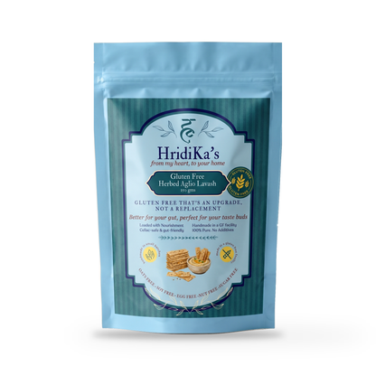Front of the HridiKa's Gluten Free Herbed Aglio Lavash 150 g pack, a light blue stand-up pouch with a teal label, on a plain white studio background