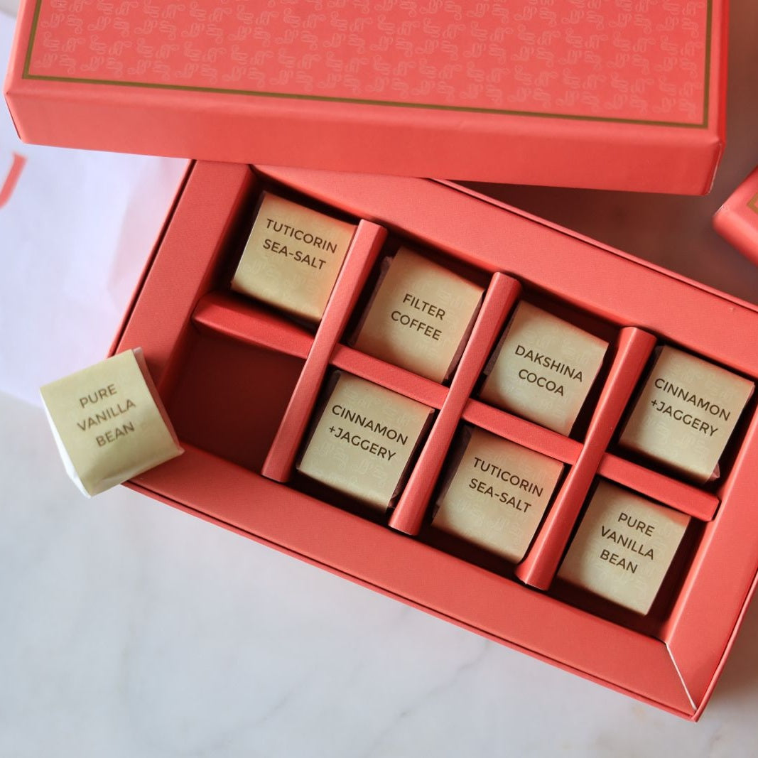 An open Inippu Indulgence box of eight hand-rolled fudge-toffee pieces