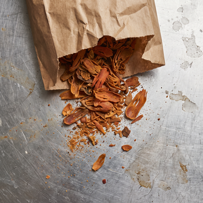 Mace blades spilling from a paper bag