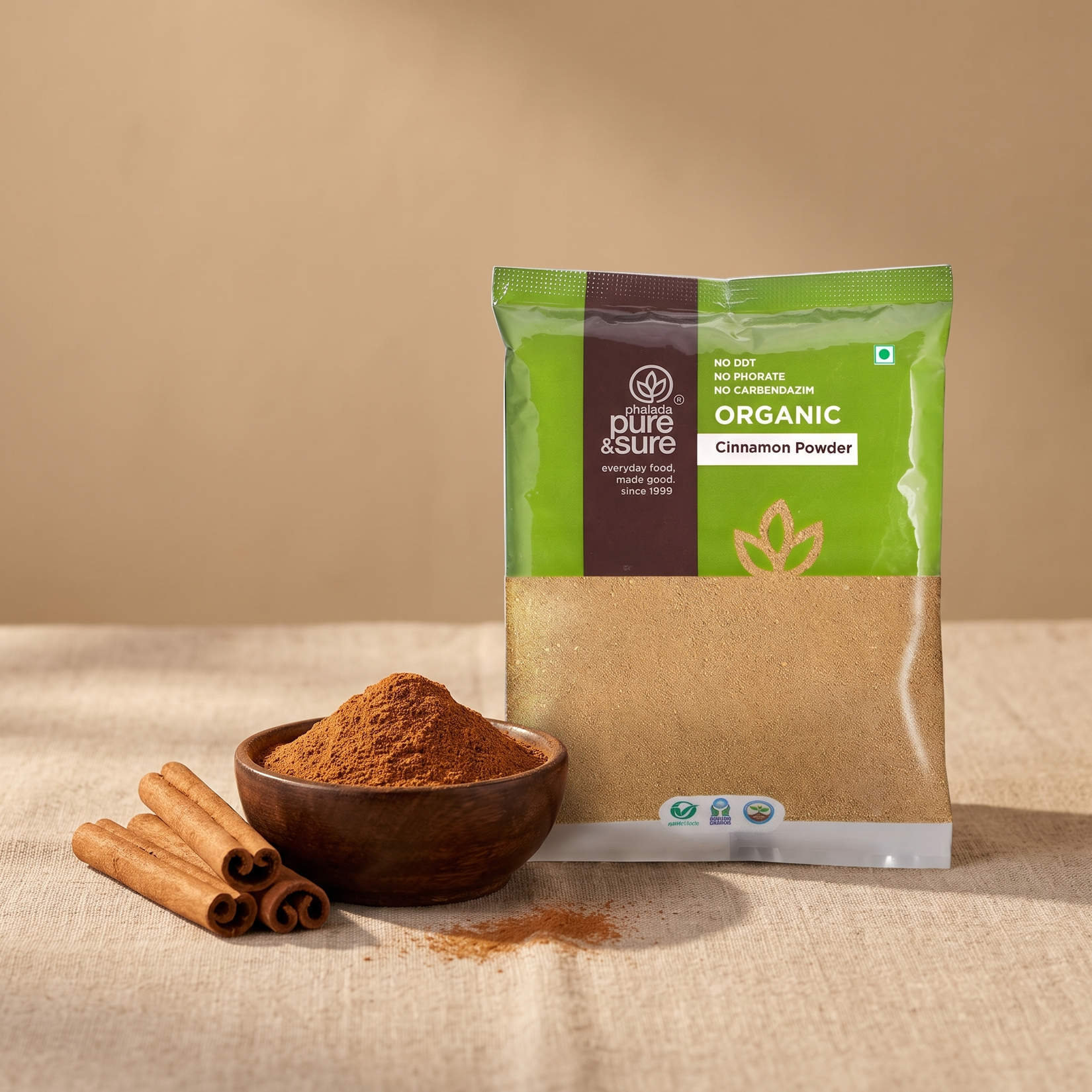 Pack with a bowl of cinnamon powder and cinnamon quills