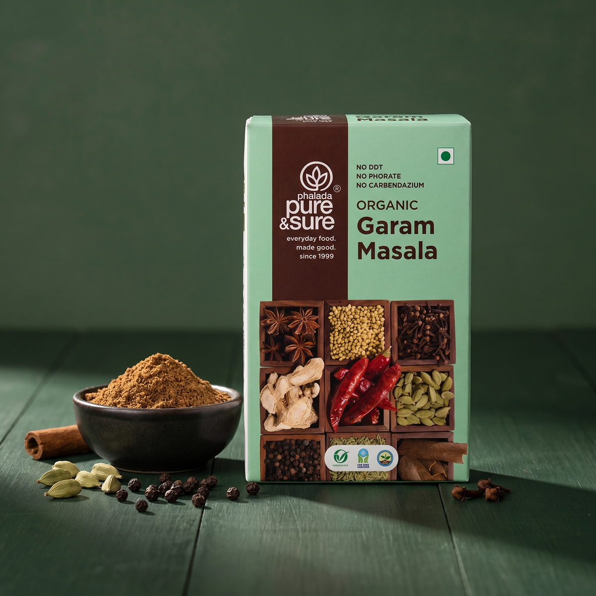 Carton with a bowl of garam masala and whole spices