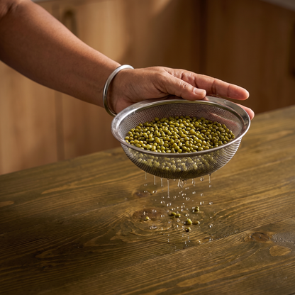 Rinsing whole green gram in a bowl