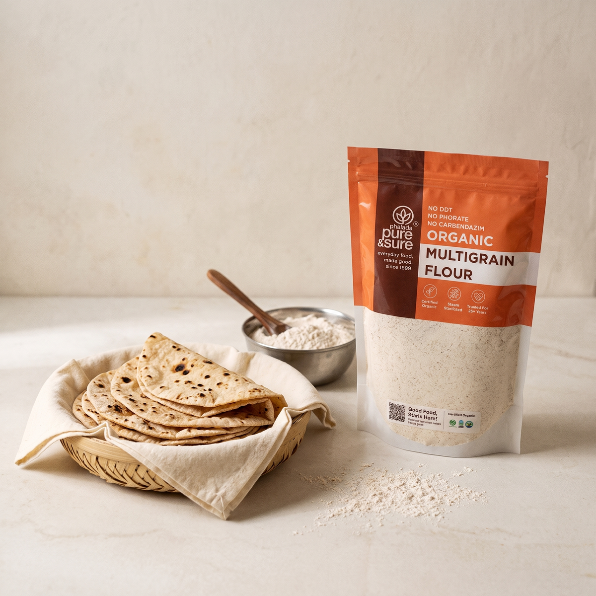 Fresh rotis in a cloth-lined basket beside the multigrain flour pack in a bright kitchen