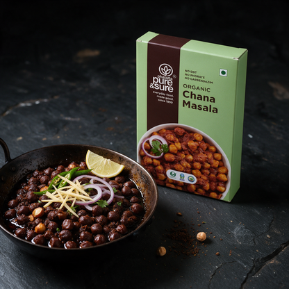 The Pure & Sure chana masala carton beside a karahi of dark pindi chole with ginger juliennes, green chilli, onion and lemon