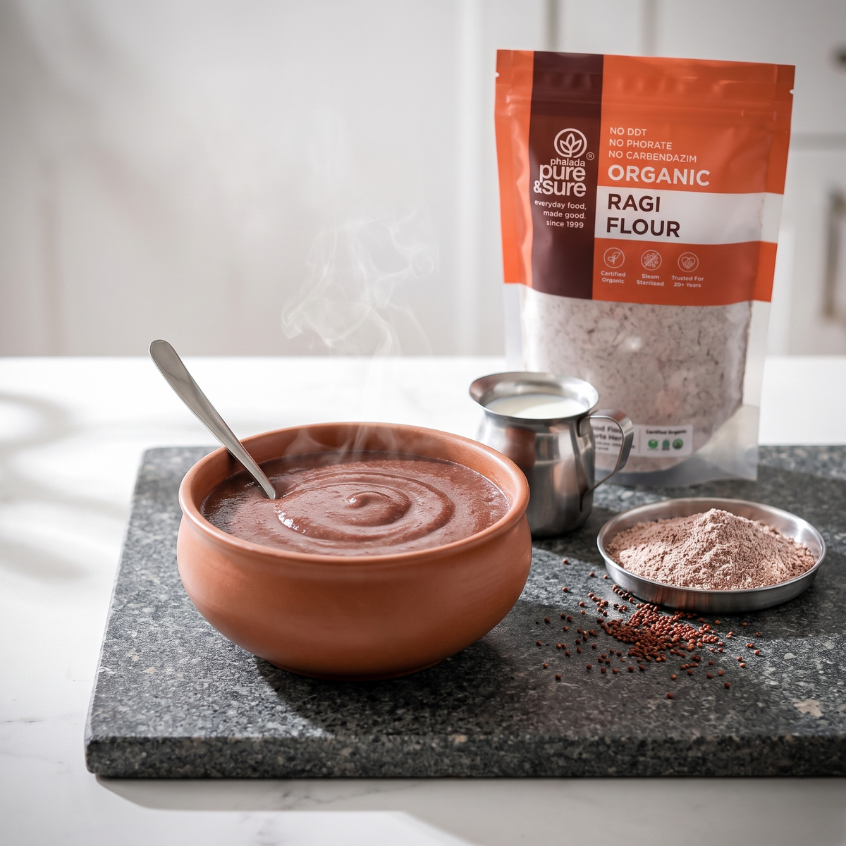 A warm bowl of ragi porridge served in a terracotta bowl with the ragi flour pack behind
