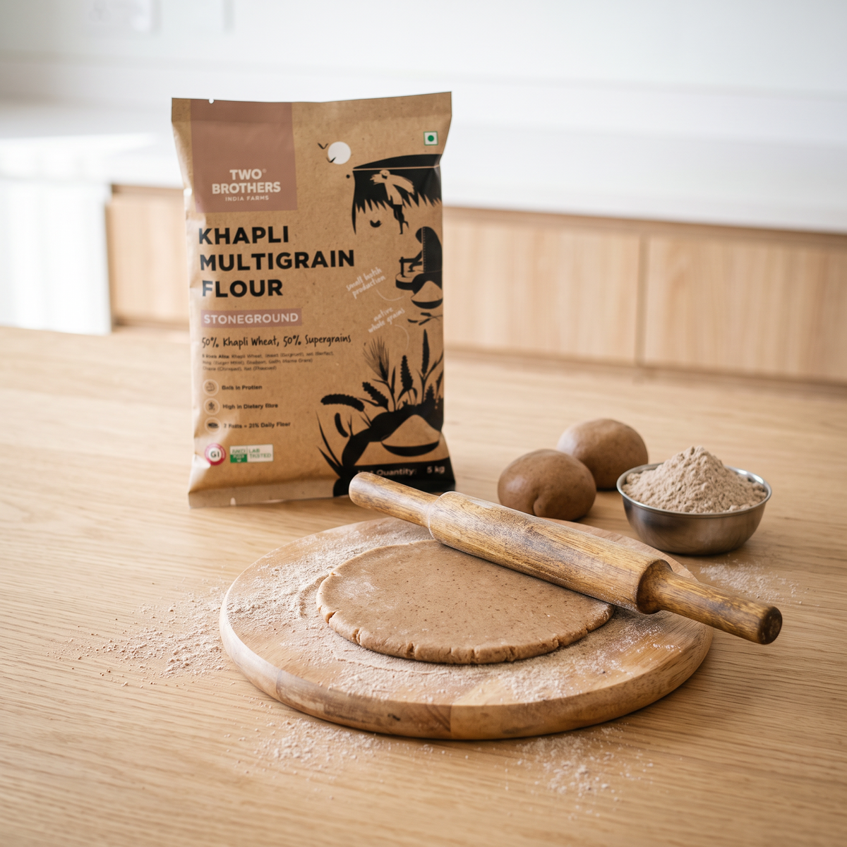 Rolling out a multigrain roti on a floured chakla with the Khapli Multigrain Atta pack behind
