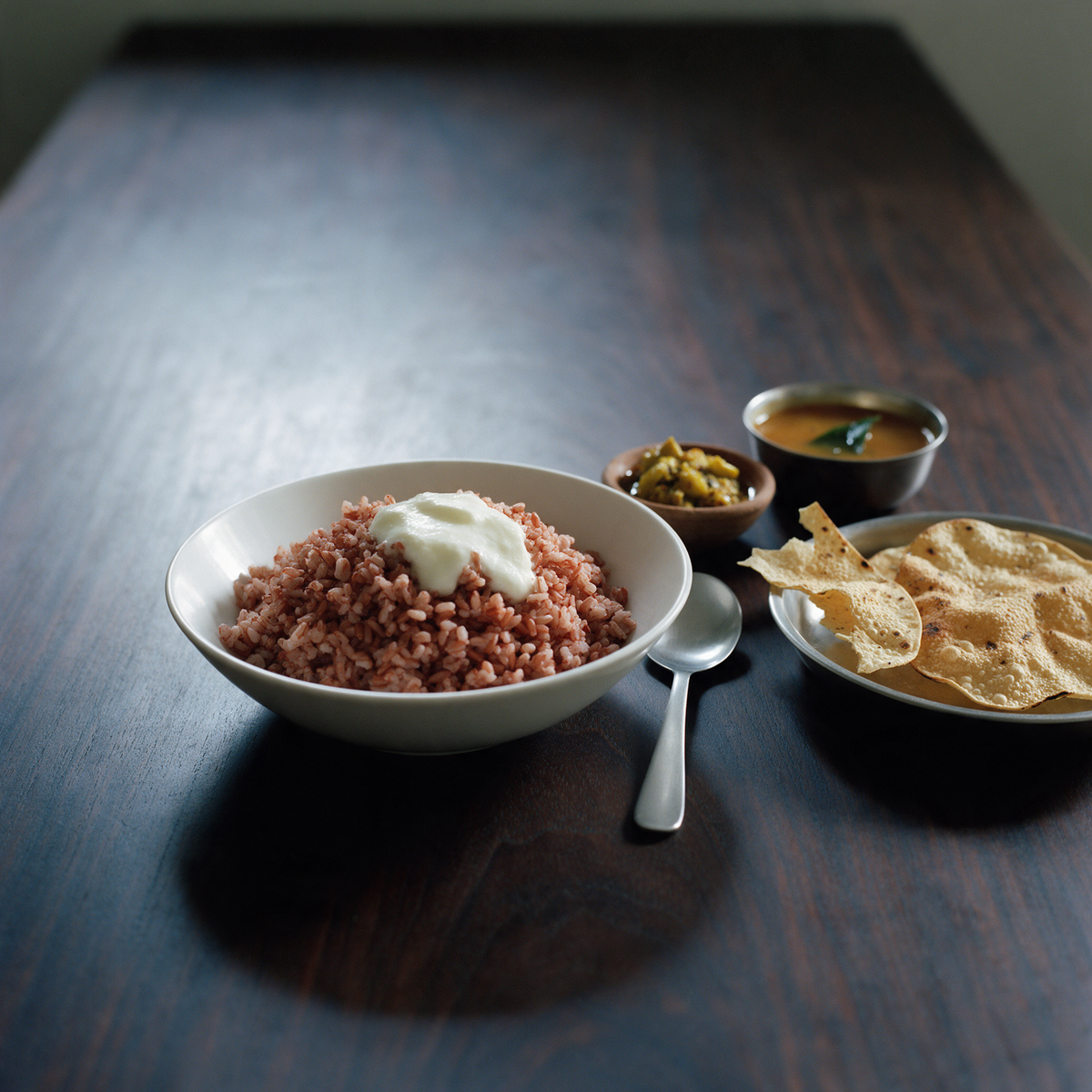 Cooked red rice with curd on a dining table