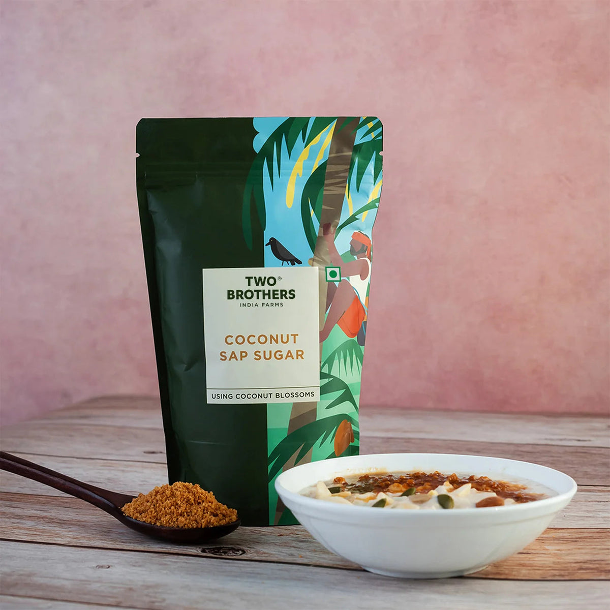 purepicked Two Brothers Organic Farms coconut sap sugar in a green pouch with a wooden spoon and bowl of porridge