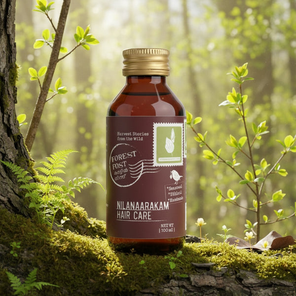 purepicked Nilanarakam hair oil in a brown glass bottle with a gold cap, set on a mossy tree trunk in a forest.